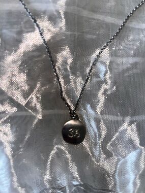 Karma Silver OM Disc Pendant Necklace - symbol is on both sides.